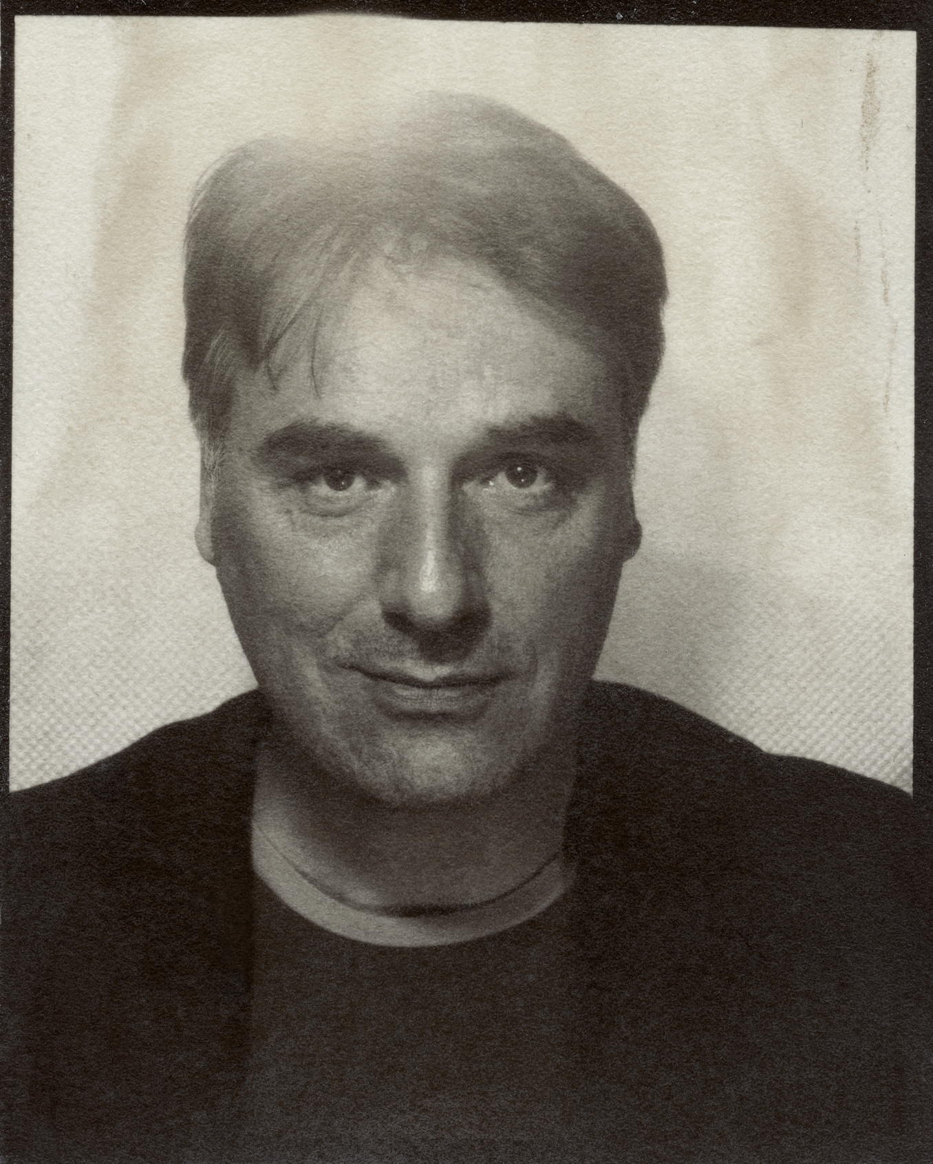 young man side profile having beard trimmed with scissors